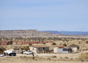 The sun shines on homes in To'hajiilee, New Mexico on November 15, 2021. Like many other tribal communities in the Southwest, limited access to clean water poses health risks to residents.
